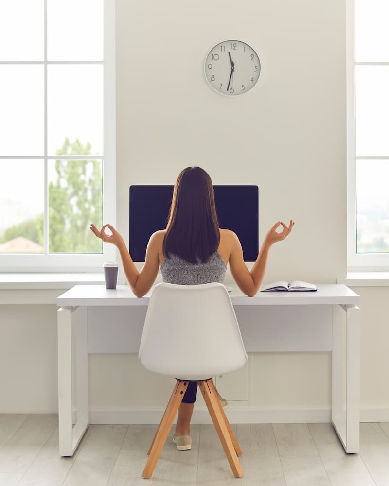woman mediating at her desk