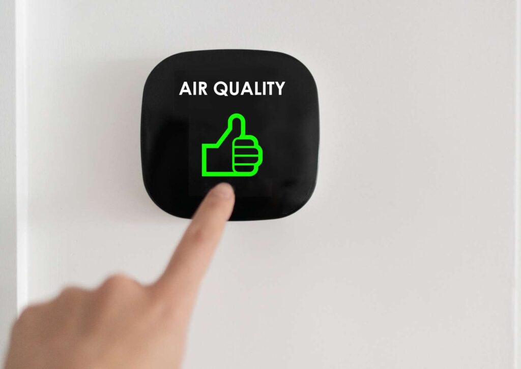 a picture of air quality, showing an image of a sensor and someones hand